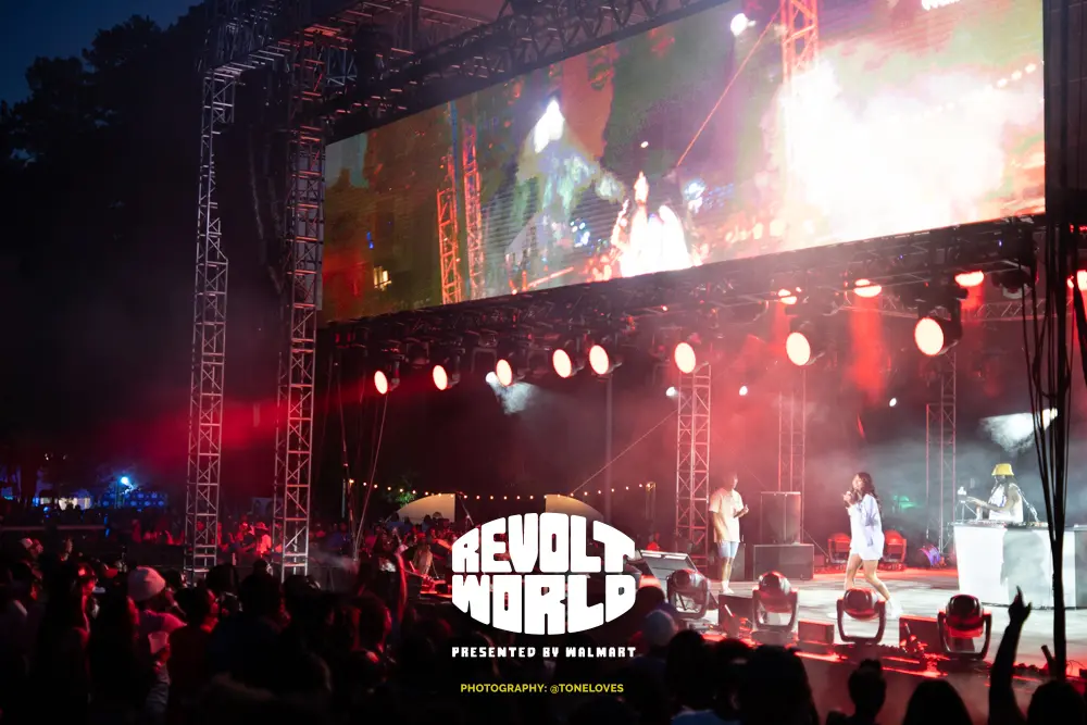 Revolt World 2023 stage with Lala Milan serving as Master of Ceremony.